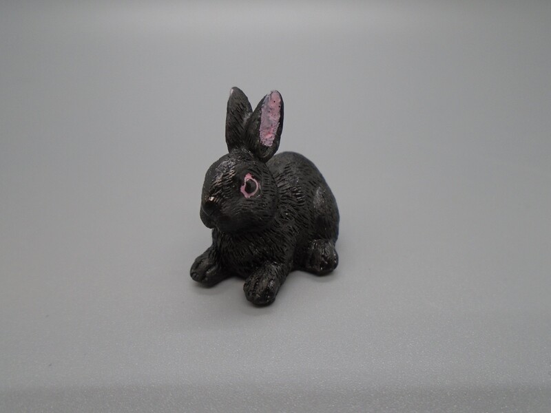 BLACK RABBIT LYING