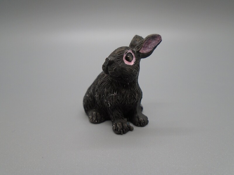BLACK RABBIT SITTING