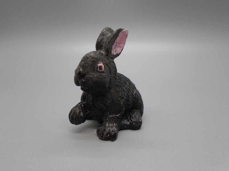 BLACK RABBIT WITH PAW UP