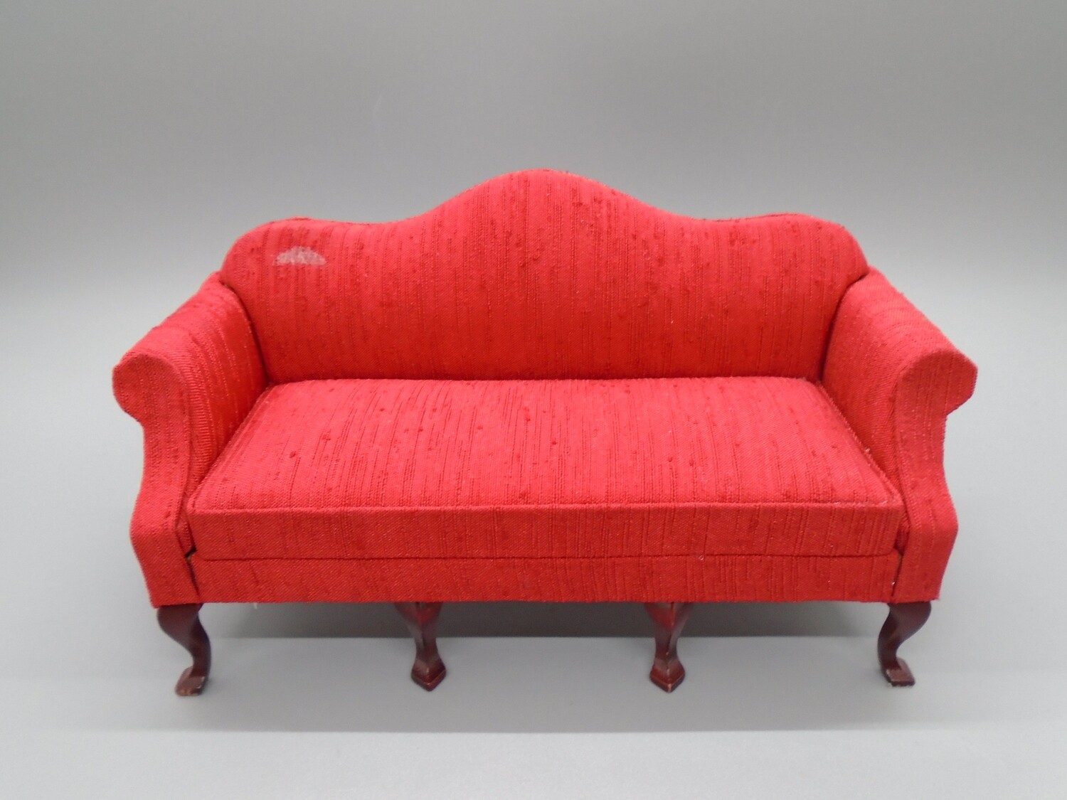 RED SOFA WITH METALLIC THREAD DETAIL