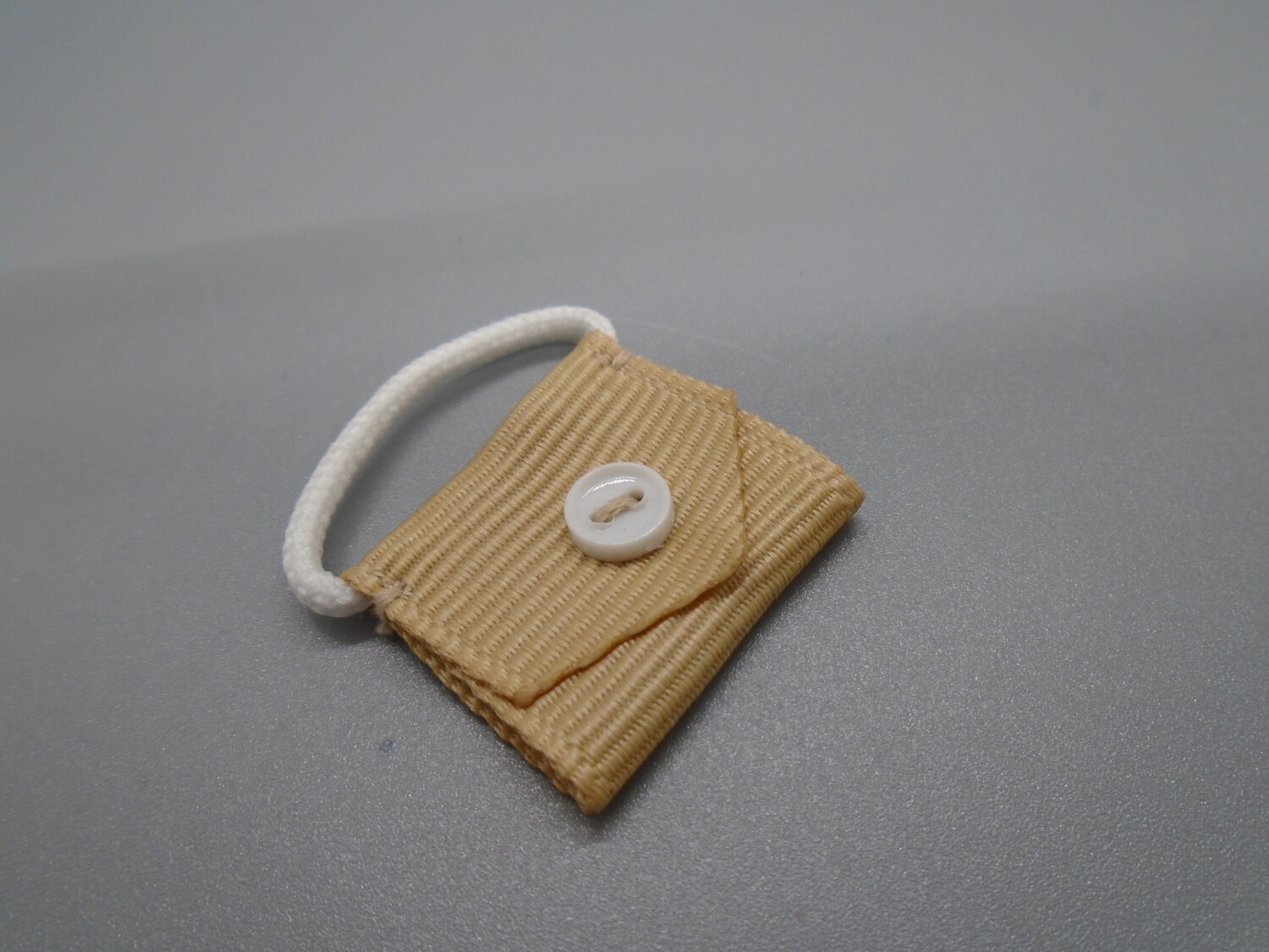 BEIGE BAG WITH BUTTON