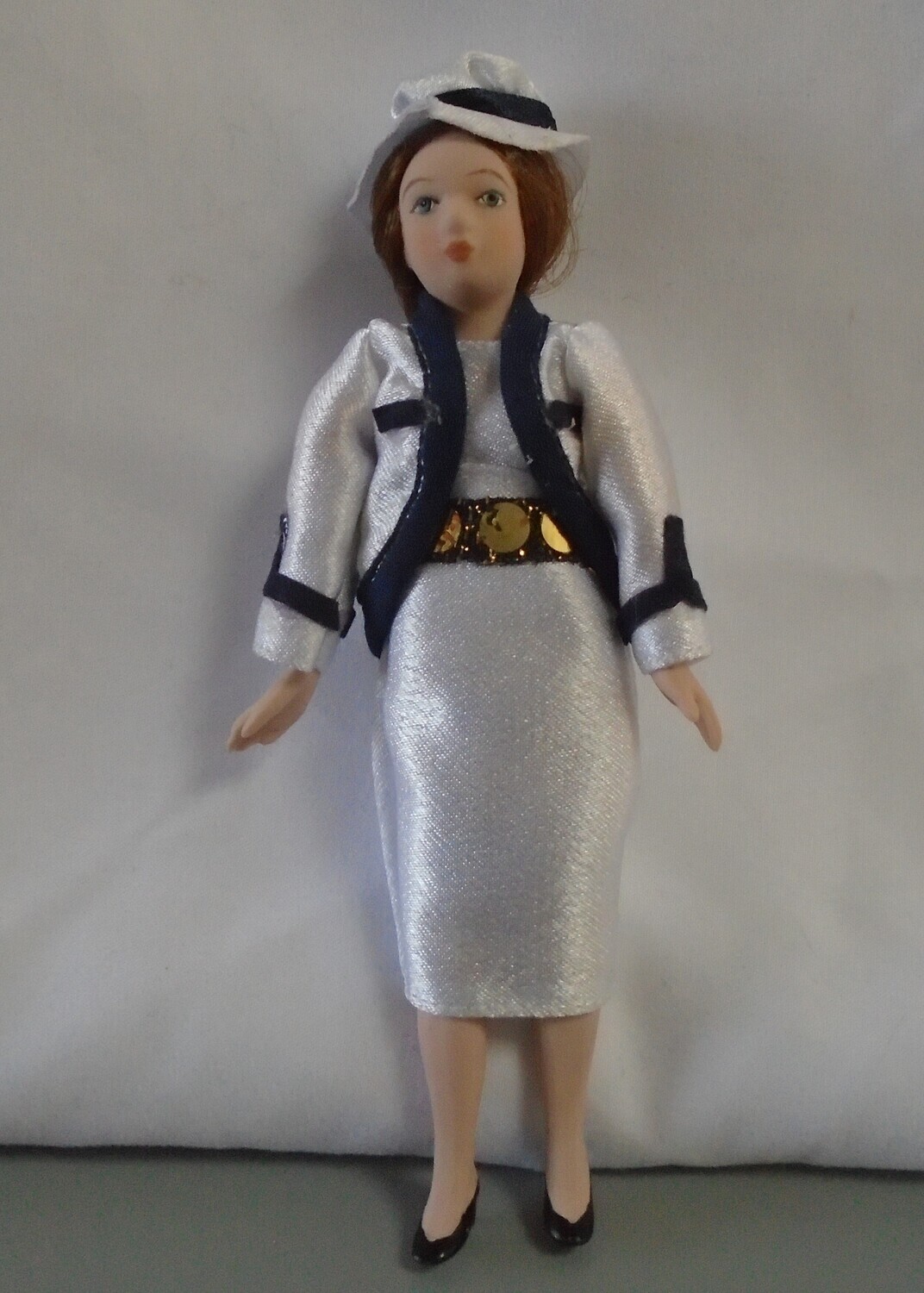 LADY IN SMART WHITE OUTFIT AND HAT