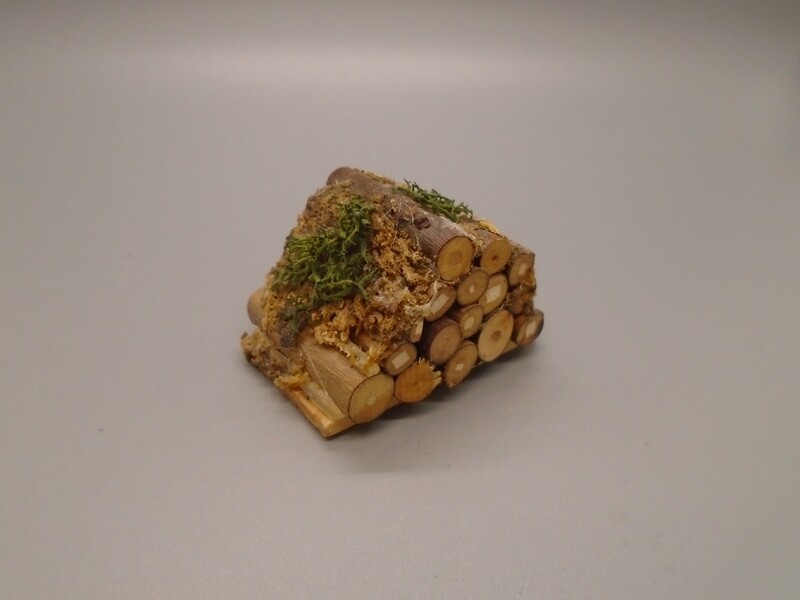 PILE OF LOGS COVERED IN MOSS