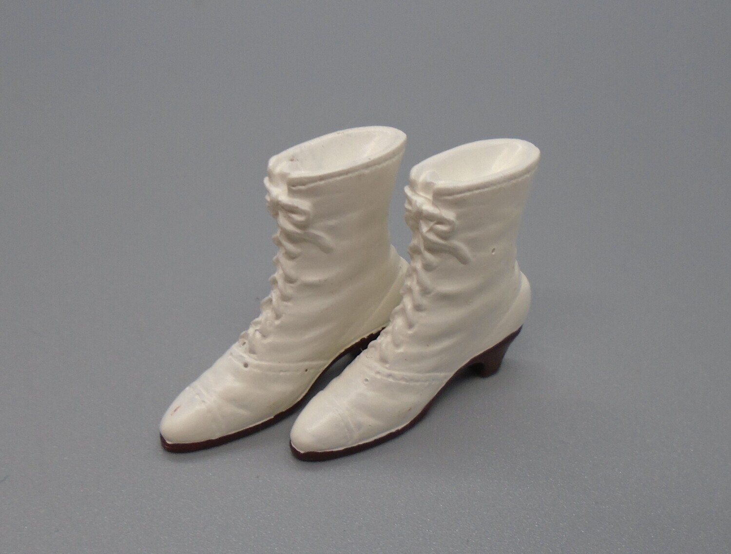 PAIR OF WHITE LACE UP BOOTS
