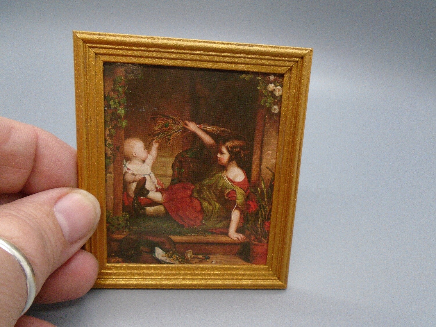 GIRL PLAYING WITH BABY PICTURE WITH INFORMATION ABOUT ORIGINAL ON REVERSE