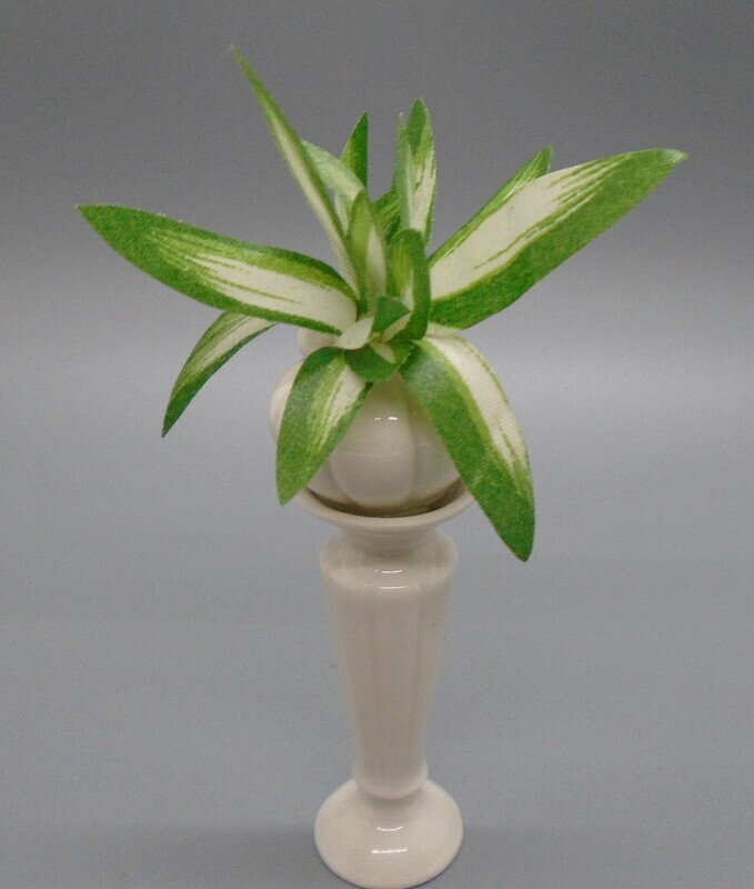 WHITE JARDINIER WITH LEAFY PLANT