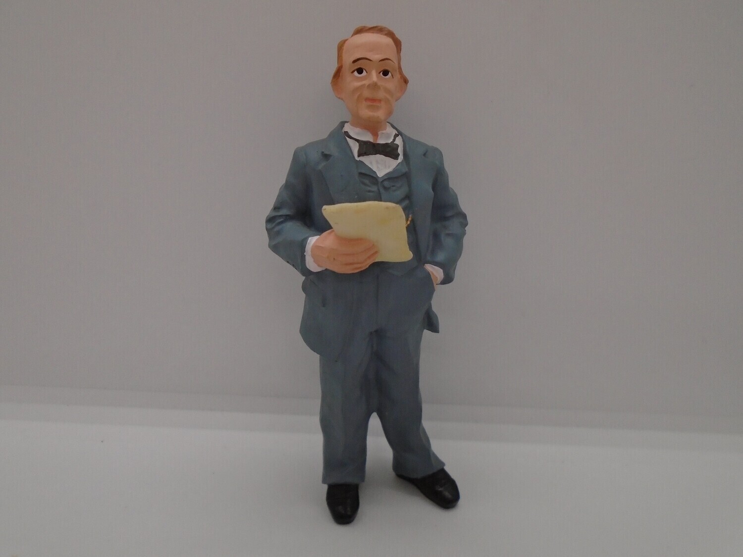 PRE-LOVED MAN STANDING IN GREY SUIT WITH LETTER