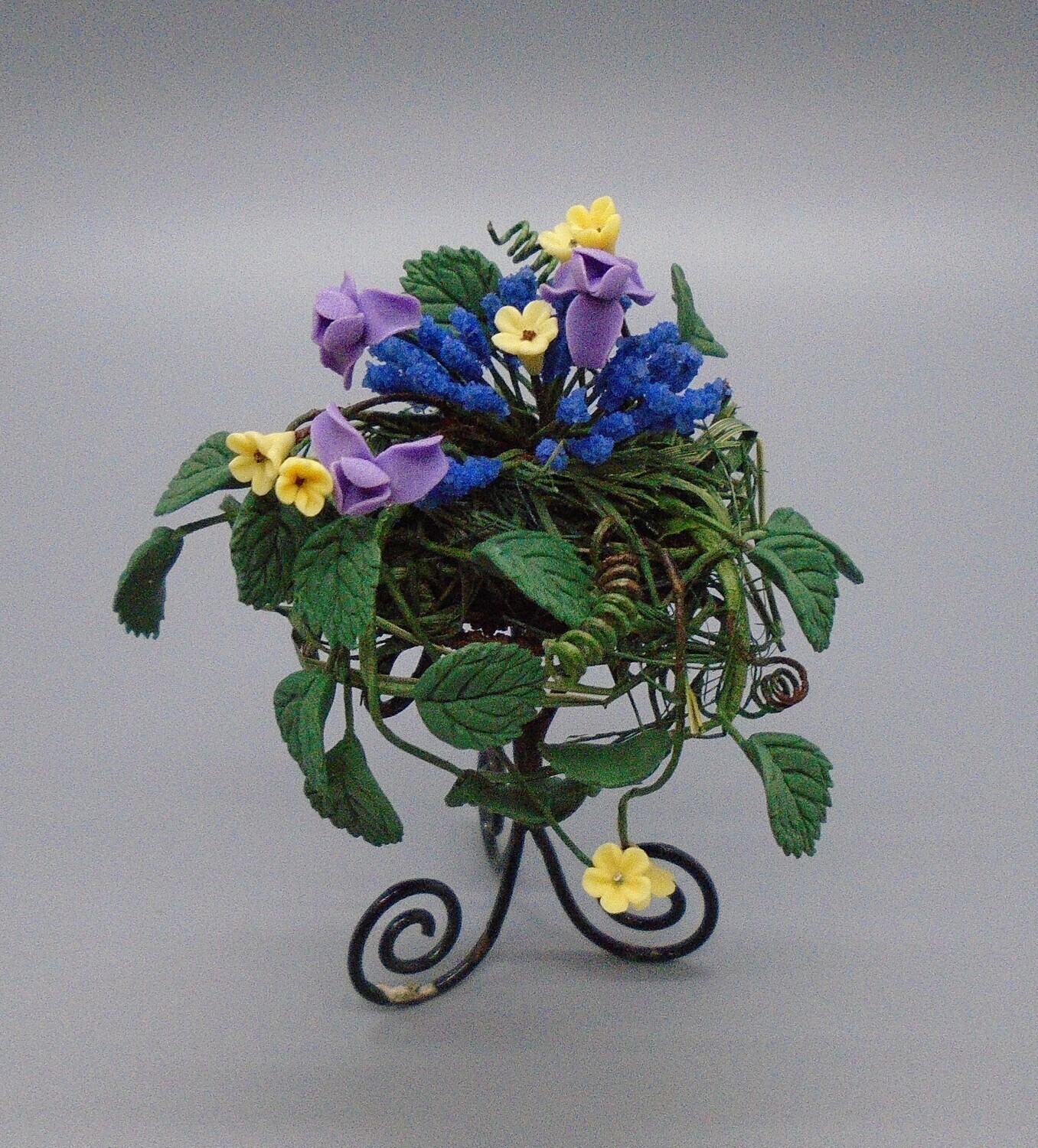 PLANT IN BASKET ON METAL STAND