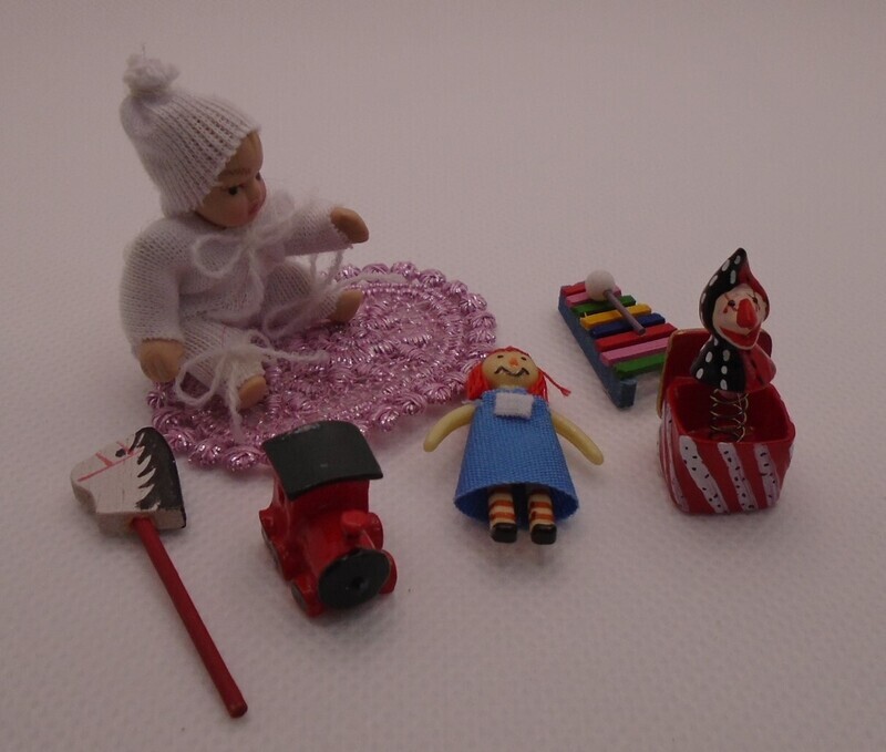 REUTTERS BABY ON RUG WITH TOYS