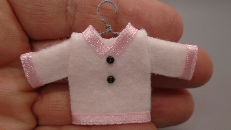 CHILDS WHITE TOP WITH PINK TRIM ON HANGER