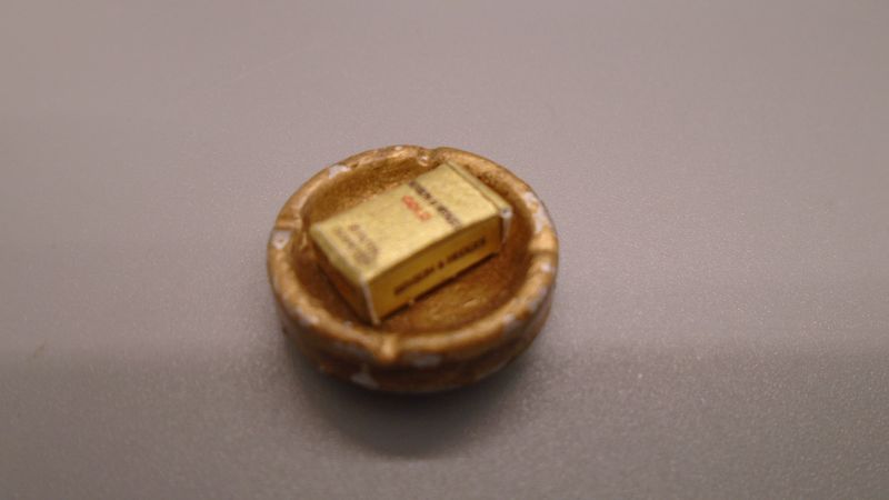 ASHTRAY WITH EMPTY PACKET IN