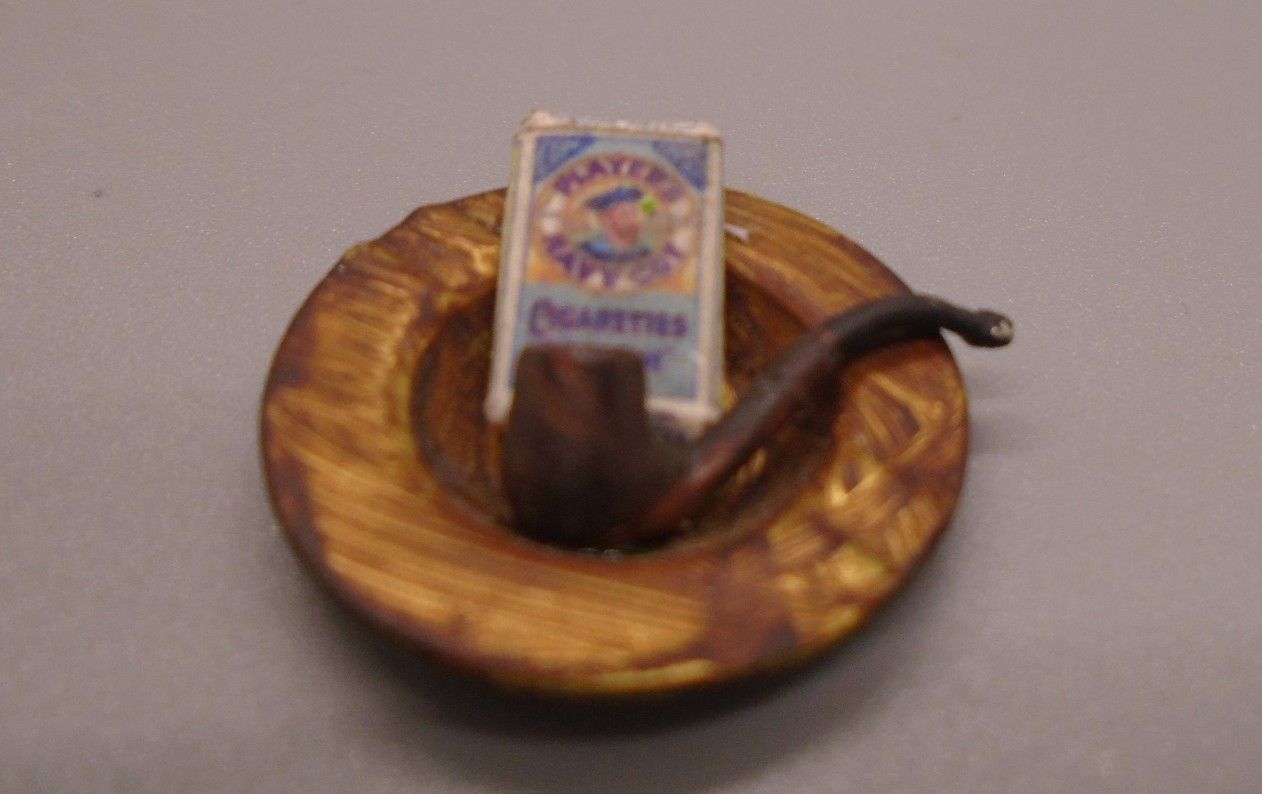 ASHTRAY WITH EMPTY PACKET AND PIPE