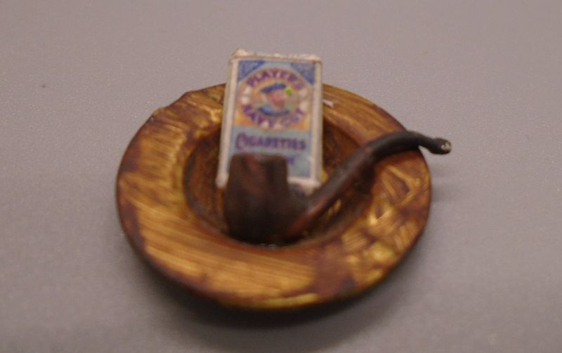 ASHTRAY WITH EMPTY PACKET AND PIPE