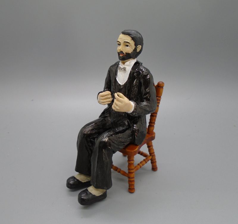 MAN SITTING IN BLACK