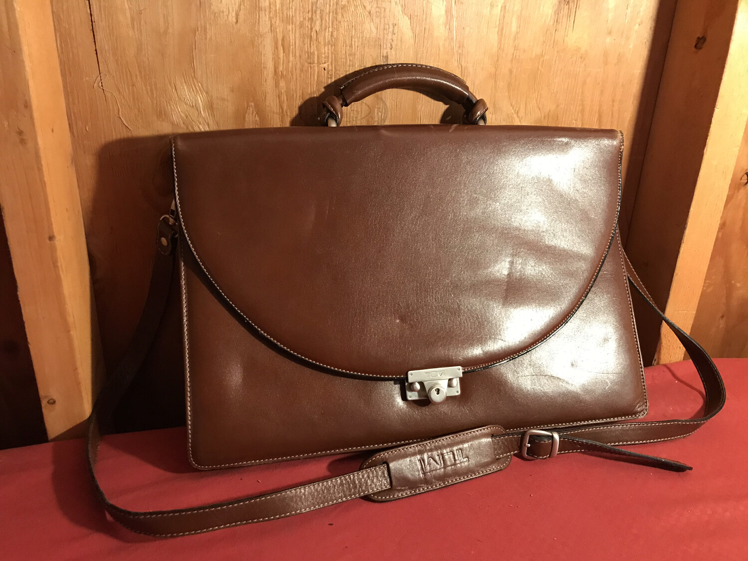 tumi leather messenger bag