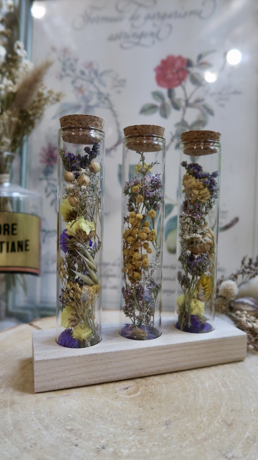 Trio de tubes fleuris sur socle en bois