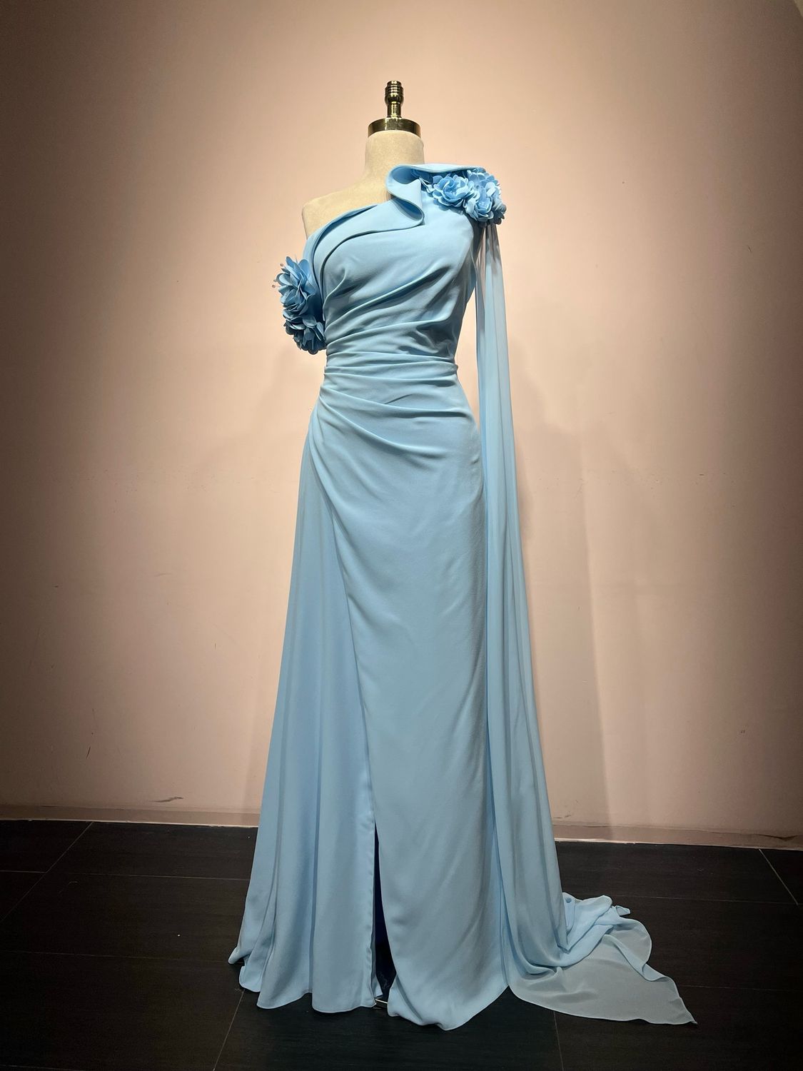 One shoulder, floral appliqués, and a statement cape