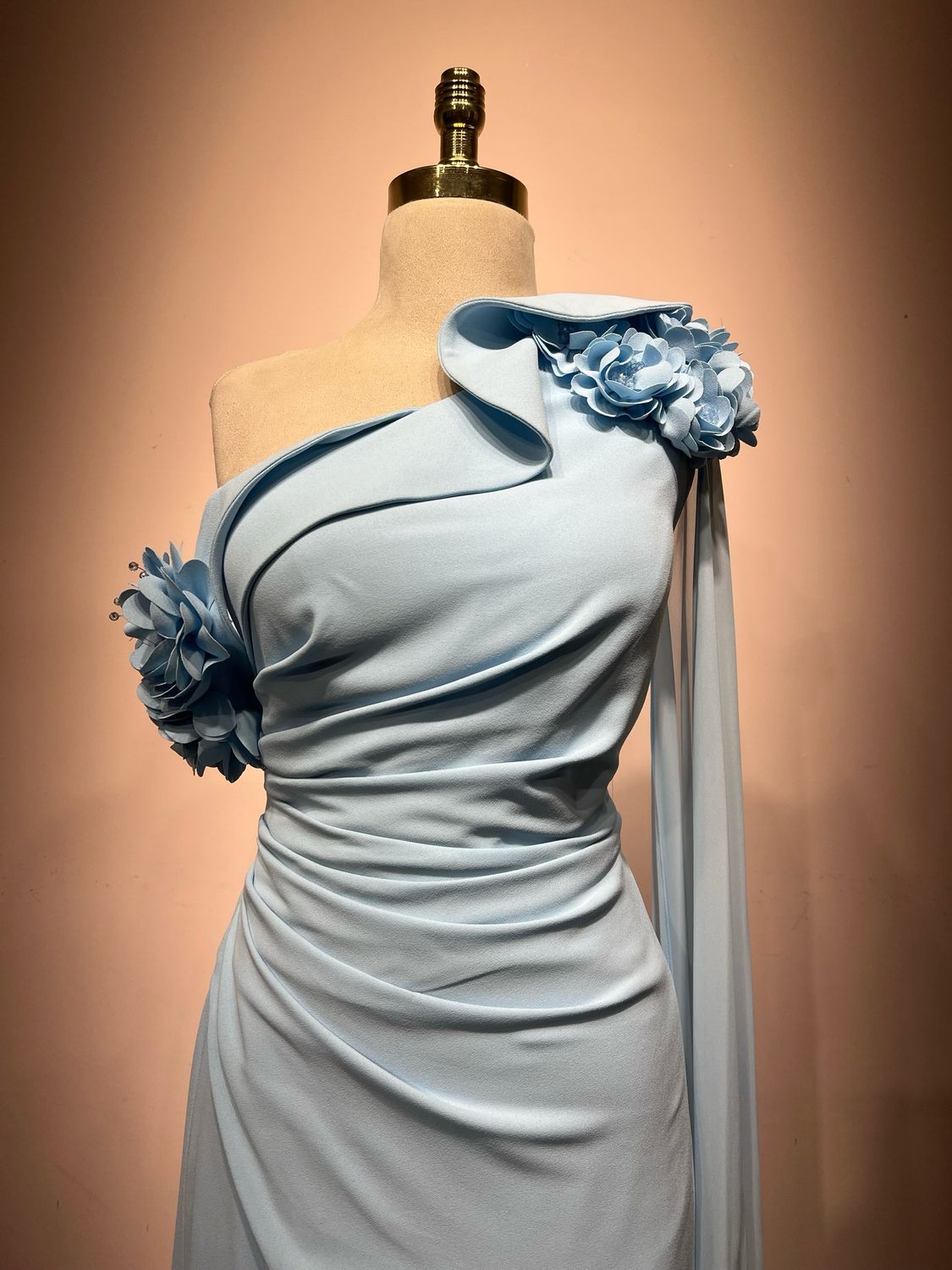 One shoulder, floral appliqués, and a statement cape