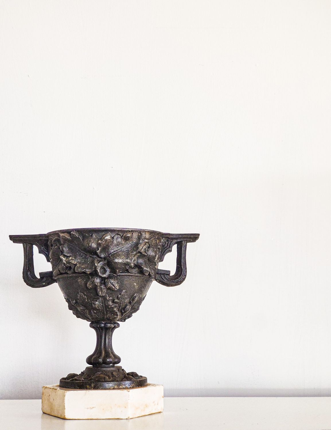 Antique Bronze Finished Oak Leaf Urn on Marble Plinth Antique Bronze Finished Oak Leaf Urn on Marble Plinth
