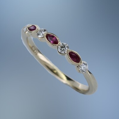 14KT YELLOW GOLD DIAMOND & RUBY BAND CONTAINING 4 ROUND BRILLIANT DIAMONDS TOTALING .19 CTS & 3 MARQ RUBIES TOTALING .14 CTS
