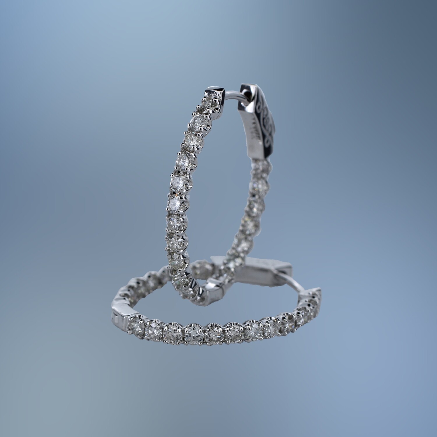 PM1800W 14KT WHITE GOLD PM1800W 14KT WHITE GOLD "IN AND OUT" DIAMOND HOOP EARRINGS FEATURING 38 ROUND BRILLIANT CUT DIAMONDS TOTALING 1.64 CTS.