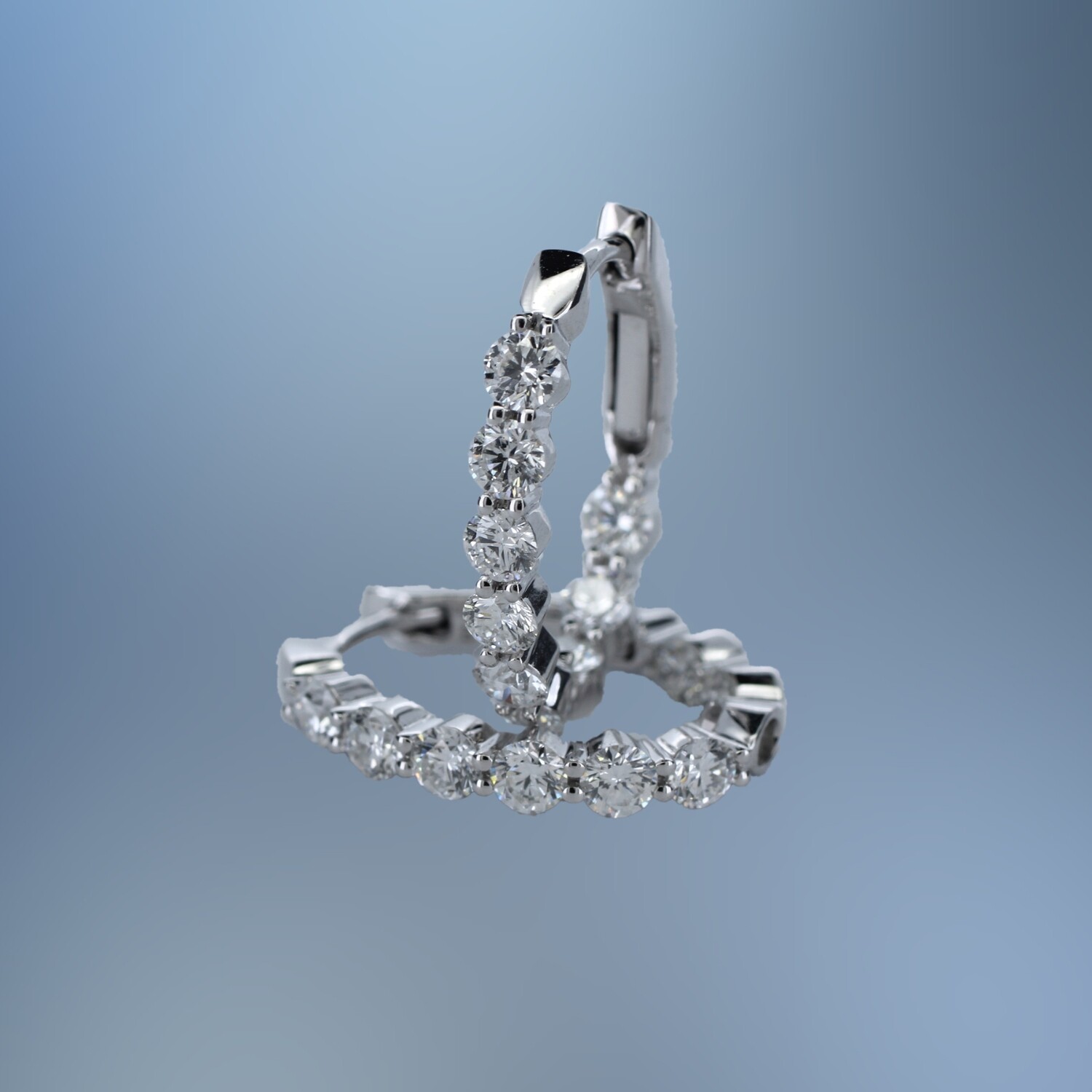 14KT WHITE GOLD OVAL DIAMOND IN AND OUT HOOP EARRINGS FEATURING 18 ROUND BRILLIANT CUT  DIAMONDS TOTALING 1.57 CTS.