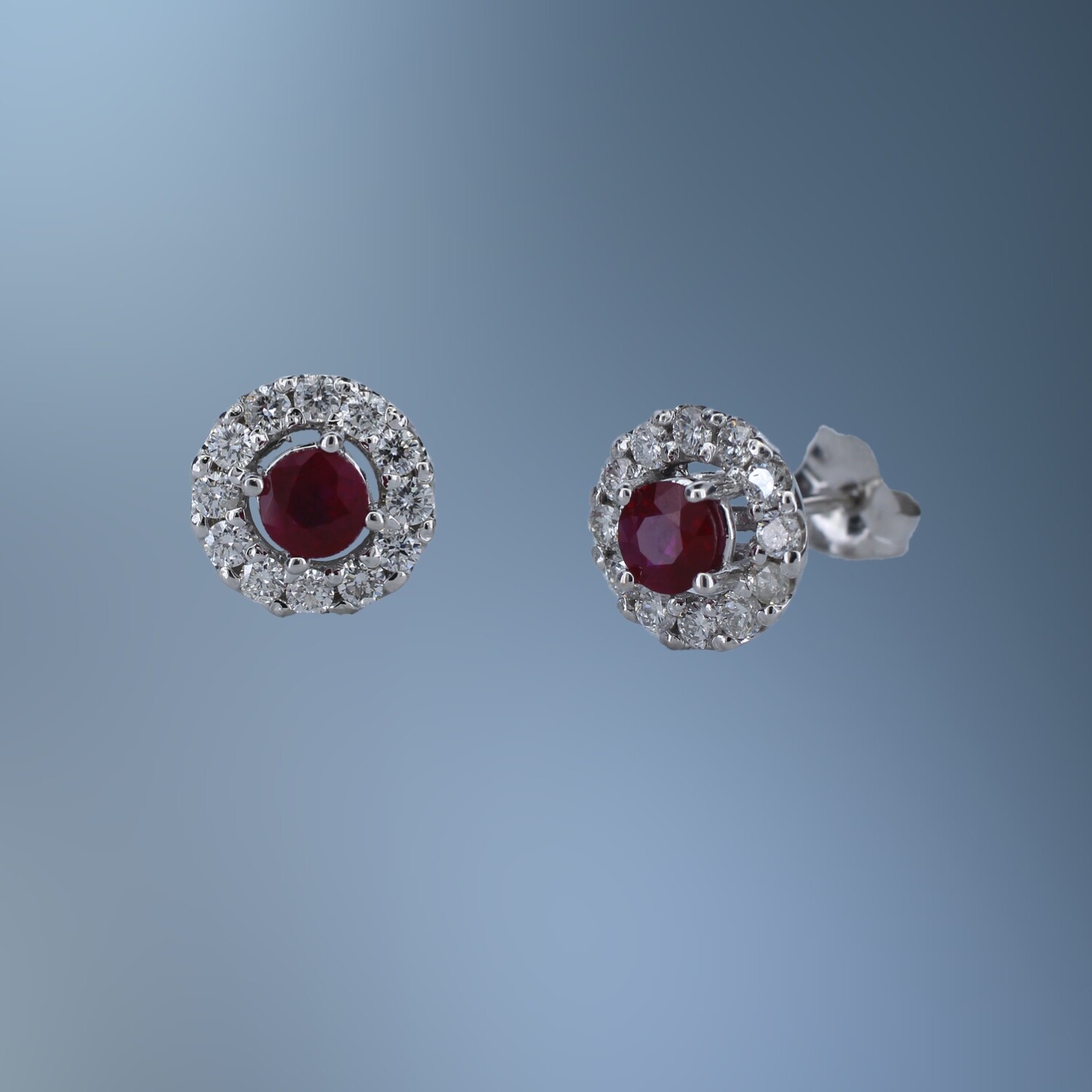 14KT WHITE GOLD RUBY AND DIAMOND EARRINGS FEATURING  2 ROUND BRILLIANT CUT RUBIES TOTALING  .60 CTS  AND 24 ROUND BRILLIANT CUT DIAMONDS TOTALING .36 CTS.