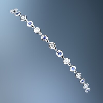 ONE 14KT WHITE GOLD LADYS NATURAL DIAMOND AND SAPPHIRE BRACELET CONTAINING .24 CTTW NATURAL SAPPHIRES AND .15 CTTW NATURAL ROUND BRILLIANT CUT DIAMONDS WITH A LOBSTER CLAW CLASP