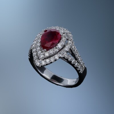 18KT WHITE GOLD DIAMOND & RUBY RING FEATURING 1 PEAR SHAPE RUBY TOTALING 1.54 CTS AND ROUND BRILLIANT CUT DIAMONDS TOTALING 1.15 CTS