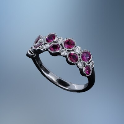 18KT WHITE GOLD DIAMOND & RUBY BAND FEATURING 9 ROUND RUBIES TOTALING 1.11 CTS & 9 ROUND BRILLIANT DIAMONDS TOTALING .32 CTS