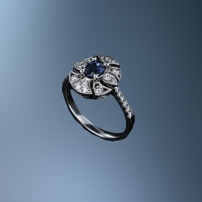 14KT WHITE GOLD SAPPHIRE RING FEATURING AN OVAL SAPPHIRE TOTALING 0.50 CTS AND 26 DIAMONDS TOTALING 0.45 CTS