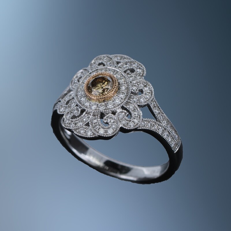 18KT WHITE GOLD FASHION RING FEATURING A FANCY BROWN DIAMOND TOTALING 0.23 CTS & 96 ROUND BRILLIANT CUT DIAMONDS TOTALING 0..41 CTS