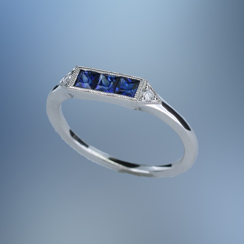 14KT WHITE GOLD SAPPHIRE & DIAMOND BAND FEATURING 3 PRINCESS CUT SAPPHIRES TOTALING .46 CTS & 2 ROUND BRILLIANT DIAMONDS TOTALING .04 CTS