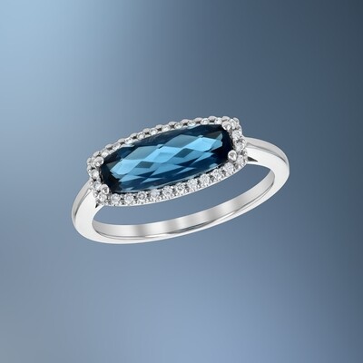 14KT WHITE GOLD BLUE TOPAZ AND DIAMOND FASHION RING FEATURING ROUND BRILLIANT CUT DIAMONDS TOTALING 0.11 CTS