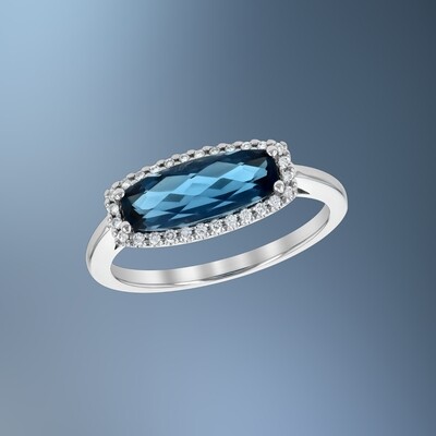 14KT WHITE GOLD BLUE TOPAZ AND DIAMOND FASHION RING FEATURING ROUND BRILLIANT CUT DIAMONDS TOTALING  0.11 CTS