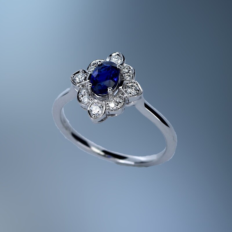 14KT WHITE GOLD DIAMOND & SAPPHIRE RING FEATURING ONE .65 CT OVAL SAPPHIRE & 12 ROUND BRILLIANT DIAMONDS TOTALING .16 CTS