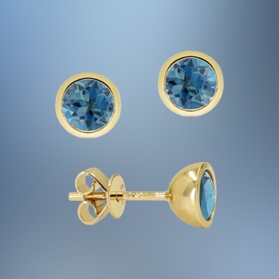 14 KARAT YELLOW GOLD BEZEL SET BLUE TOPAZ STUD EARRINGS CONTAINING TWO ROUND BLUE TOPAZ TOTALING 1.24 CARATS 14 KARAT YELLOW GOLD BEZEL SET BLUE TOPAZ STUD EARRINGS CONTAINING TWO ROUND BLUE TOPAZ TOTALING 1.24 CARATS