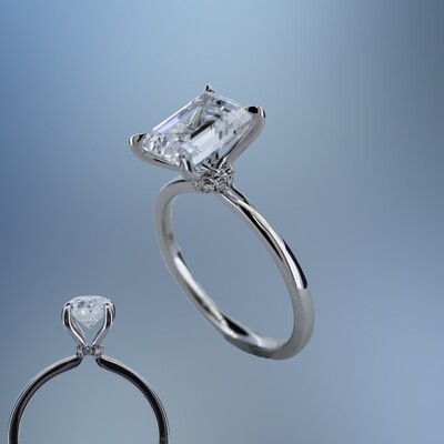 ONE 14KT WHITE GOLD ENGAGEMENT RING FEATURING A DIAMOND HALO AT THE BASE OF THE CENTER STONE
