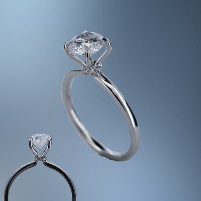 ONE 14KT WHITE GOLD ENGAGEMENT RING FEATURING A DIAMOND HALO AT THE BASE OF THE CENTER STONE