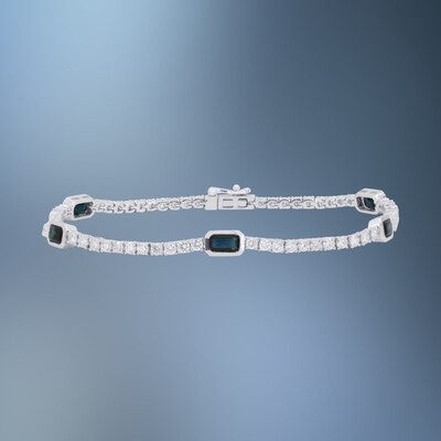 ONE 14KT WHITE GOLD LADIES BLUE SAPPHIRE AND DIAMOND TENNIS BRACELET CONTAINING 5 EMERALD CUT BLUE SAPPHIRES, 1.96 CTS TOTAL AND 67 NATURAL ROUND BRILLIANT CUT DIAMONDS, 2.28 CTS TOTAL. BRACELET IS 7"