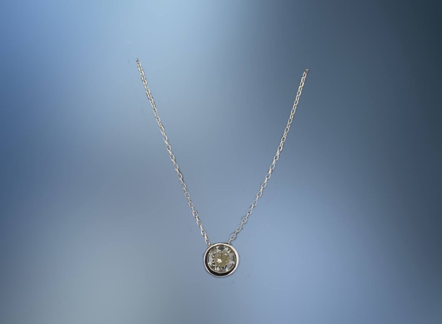 ONE 18KT WHITE GOLD LADIES BEZEL SET DIAMOND PENDANT CONTAINING ONE .31 CT NATURAL ROUND BRILLIANT CUT DIAMOND ON A 17 ONE 18KT WHITE GOLD LADIES BEZEL SET DIAMOND PENDANT CONTAINING ONE .31 CT NATURAL ROUND BRILLIANT CUT DIAMOND ON A 17" ADJUSTABLE CHAIN.