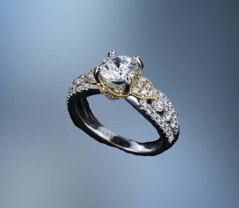 14KT TWO TONE ENGAGEMENT RING FEATURING 52 ROUND BRILLIANT CUT DIAMONDS TOTALING 0.70 CTS. 14KT TWO TONE ENGAGEMENT RING FEATURING 52 ROUND BRILLIANT CUT DIAMONDS TOTALING 0.70 CTS.