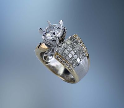 14 KT TWO TONE GOLD ENGAGEMENT RING FEATURING 74 ROUND BRILLIANT & PRINCESS CUT DIAMONDS TOTALING 2.01 CTS 14 KT TWO TONE GOLD ENGAGEMENT RING FEATURING 74 ROUND BRILLIANT & PRINCESS CUT DIAMONDS TOTALING 2.01 CTS