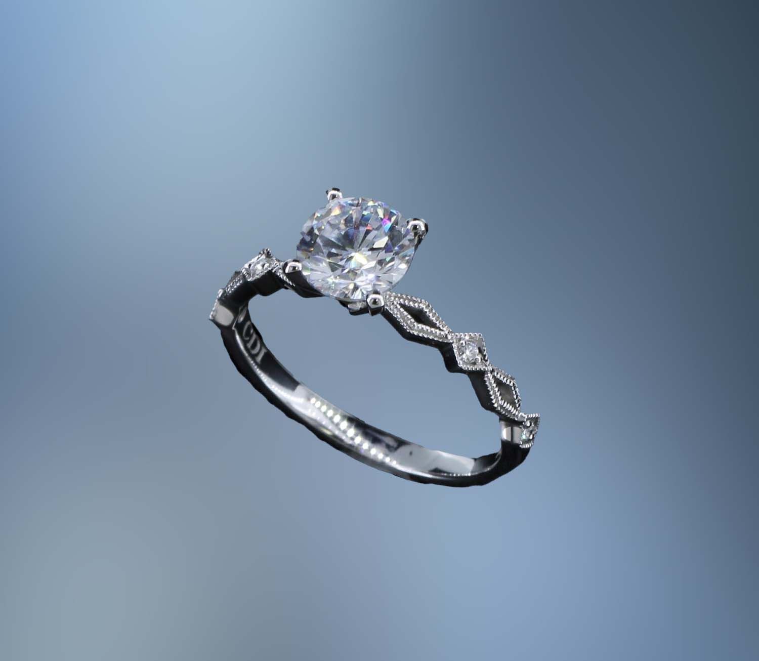 14KT WHITE GOLD ENGAGEMENT RING FEATURING 4 ROUND BRILLIANT CUT DIAMONDS TOTALING 0.03 CTS. 14KT WHITE GOLD ENGAGEMENT RING FEATURING 4 ROUND BRILLIANT CUT DIAMONDS TOTALING 0.03 CTS.