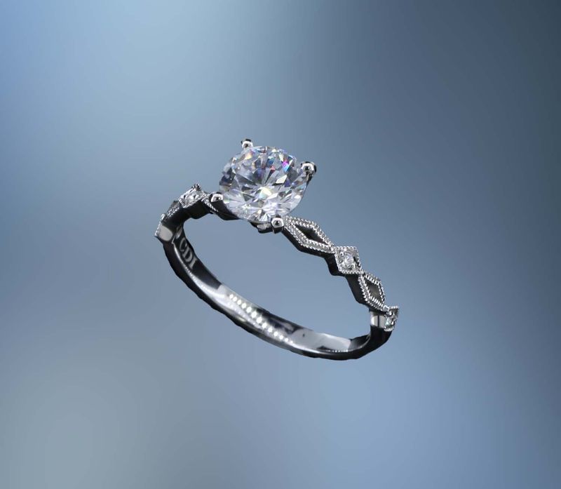 14KT WHITE GOLD ENGAGEMENT RING FEATURING 4 ROUND BRILLIANT CUT DIAMONDS TOTALING  0.03 CTS.