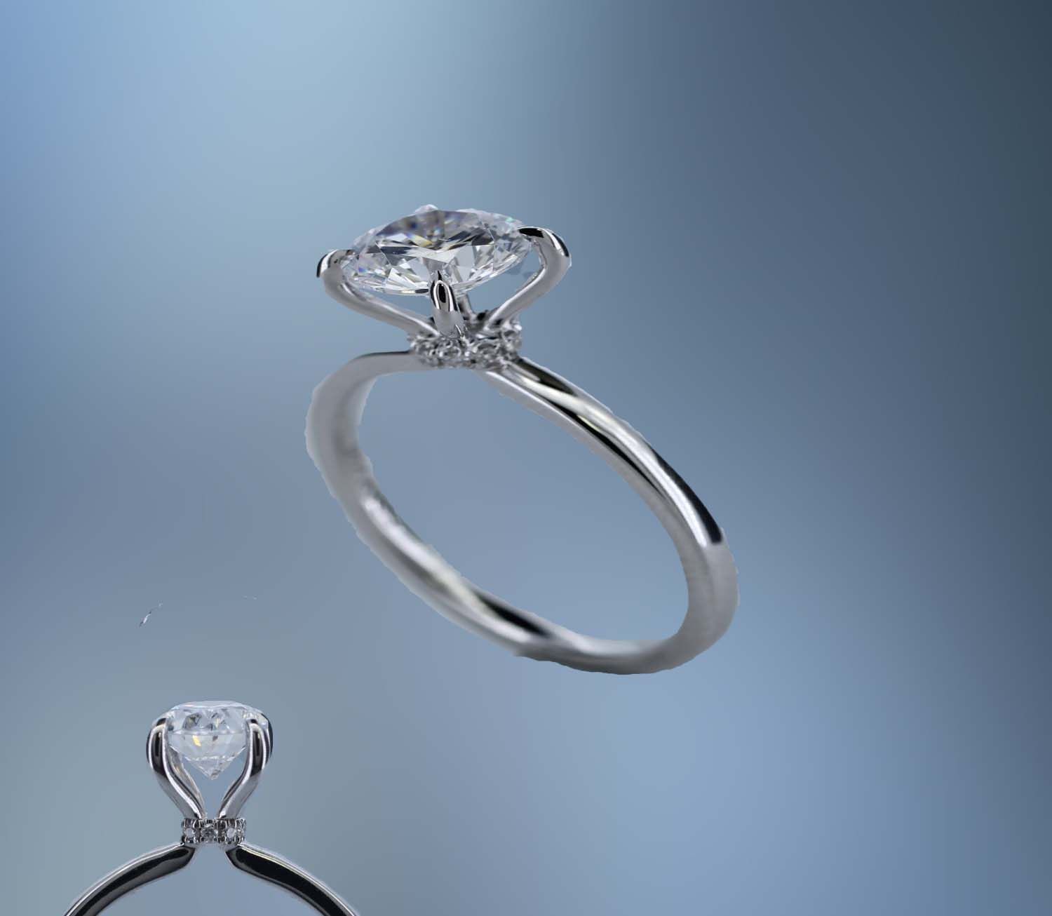 ONE 14KT WHITE GOLD ENGAGEMENT RING FEATURING A DIAMOND HALO  AT THE BASE OF THE CENTER STONE