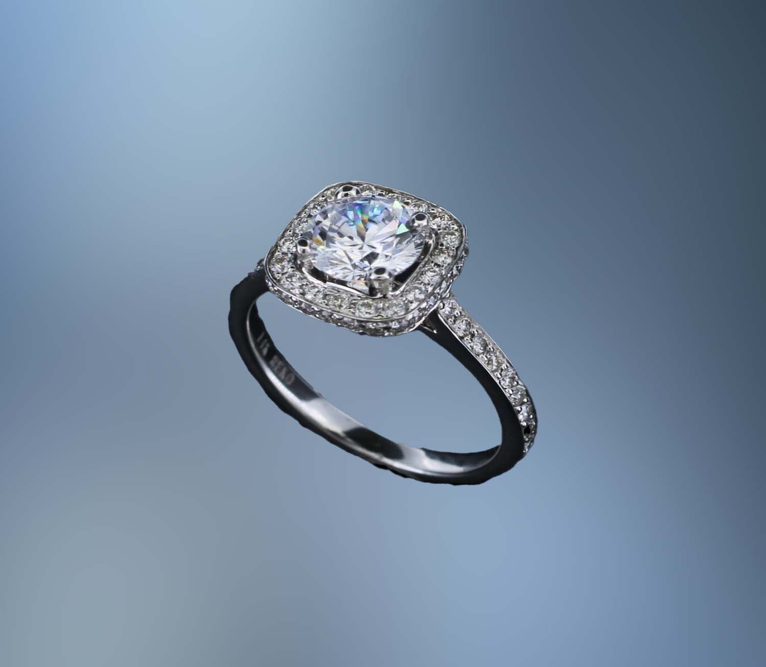 14 KT WHITE GOLD HALO STYLE ENGAGEMENT RING FEATURING 64 ROUND BRILLLIANT CUT DIAMONDS TOTALING 0.50 CTS.