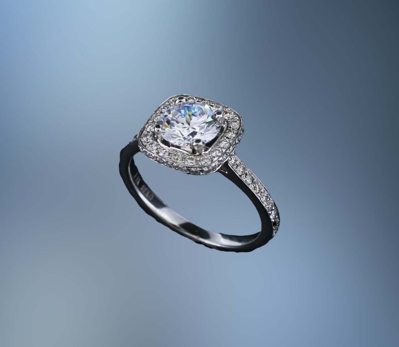 14 KT WHITE GOLD HALO STYLE ENGAGEMENT RING FEATURING 64 ROUND BRILLLIANT CUT DIAMONDS TOTALING 0.50 CTS. 14 KT WHITE GOLD HALO STYLE ENGAGEMENT RING FEATURING 64 ROUND BRILLLIANT CUT DIAMONDS TOTALING 0.50 CTS.