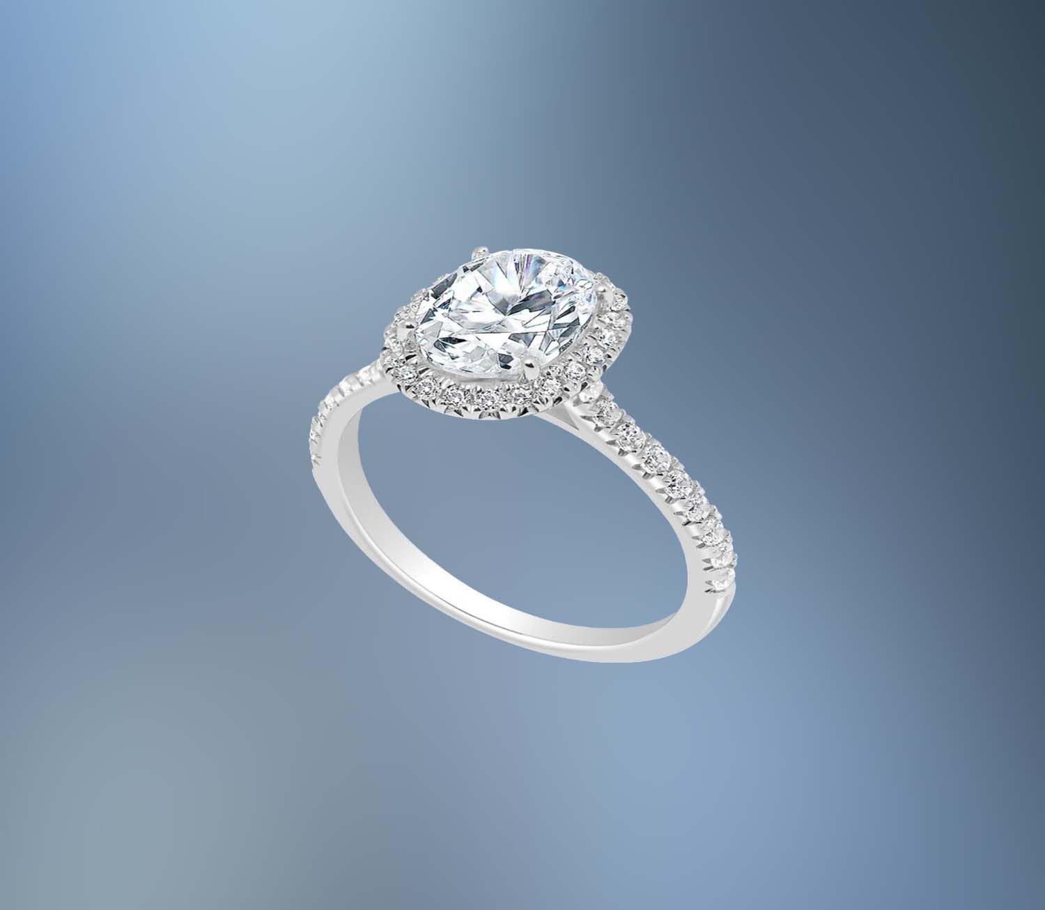 14KT WHITE GOLD OVAL HALO ENGAGEMENT RING FEATURING 40 ROUND BRILLIANT DIAMONDS TOTALING .43 CTS 14KT WHITE GOLD OVAL HALO ENGAGEMENT RING FEATURING 40 ROUND BRILLIANT DIAMONDS TOTALING .43 CTS