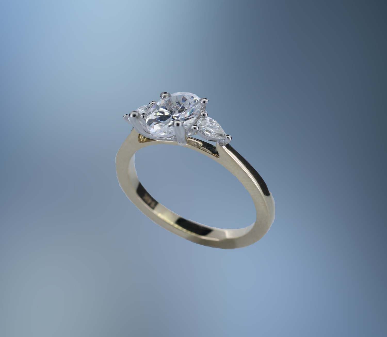 ONE 14KT YELLOW AND WHITE GOLD DIAMOND ENGAGEMENT RING CONTAINING TWO PEAR SHAPE DIAMONDS, TOTALING .20 CTS. ONE 14KT YELLOW AND WHITE GOLD DIAMOND ENGAGEMENT RING CONTAINING TWO PEAR SHAPE DIAMONDS, TOTALING .20 CTS.